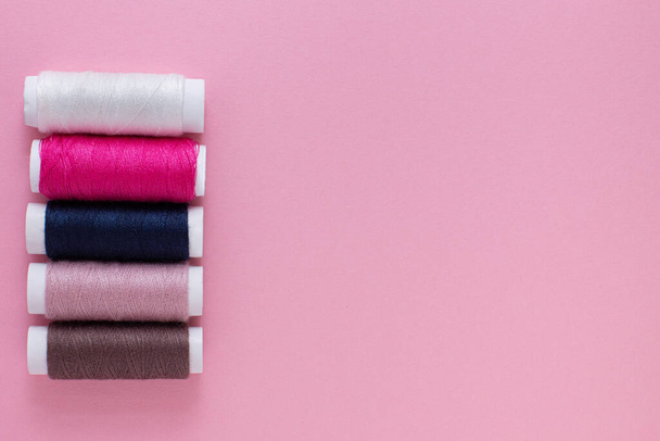 multicolored threads on a pink background. the place for your mockup - Photo, Image