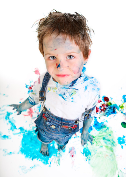 Funny photo of cute 5 years old boy painting on white background - Foto, Imagen