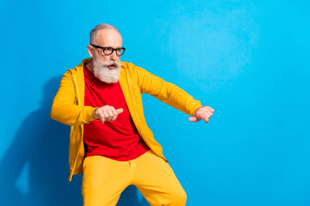 Photo of mature funky funny cool hipster man in glasses dancing look copyspace isolated on blue color background - 写真・画像