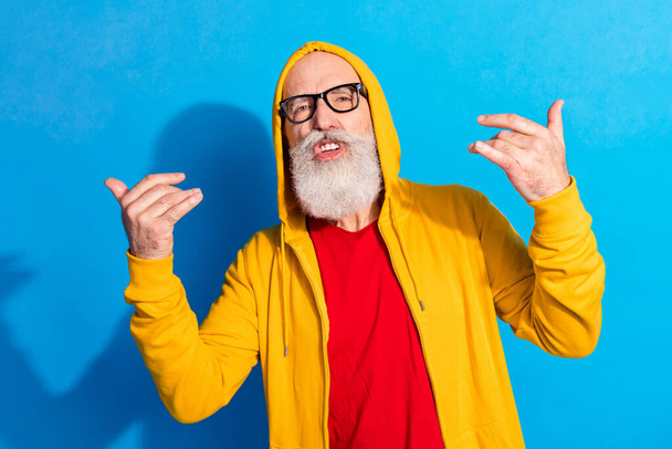 Photo of funky funny cool hipster grandfather in glasses dancing swag wear glasses isolated on blue color background - Foto, Imagem