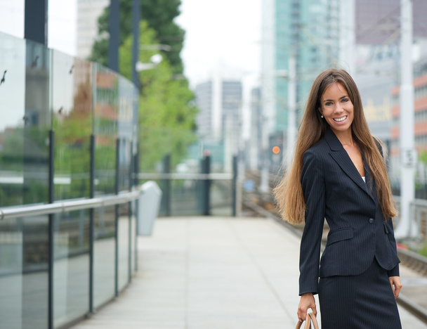 Smiling businesswoman at train station - Photo, Image