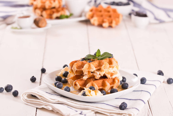 Waffles with blueberries and whipped cream. - Foto, Imagen