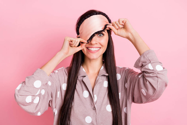 Photo of charming childish young lady nightwear hands arms mask cover eye isolated pink color background - Fotoğraf, Görsel
