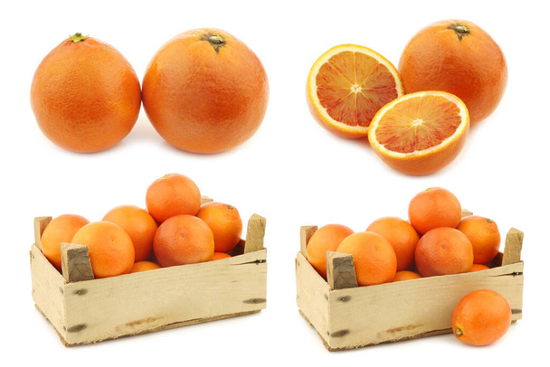 свіжі кров'яні апельсини в дерев'яній ящиці на білому тлі
 - Фото, зображення