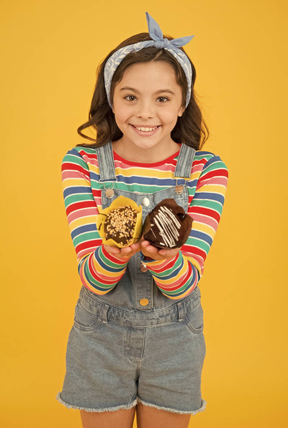 muffins are ready. cheerful carefree childhood. retro girl hold easter cake. cute little girl with tasty muffins. small kid eating a delicious cake. summer vacation and holiday. Sweet tooth concept - Φωτογραφία, εικόνα