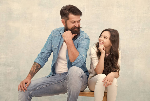 Love makes family. Happy daughter smile at father. Bearded man and little child enjoy time together. Happy family grey background. Love and care. Fathers day. Childrens day - Foto, Imagen