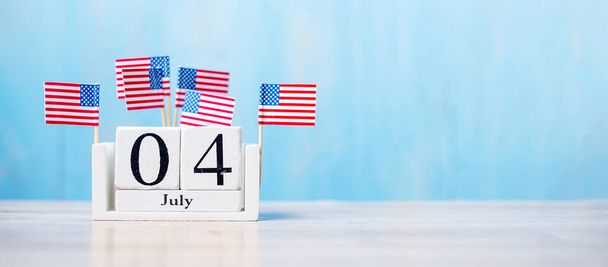 Calendrier en bois du 4 juillet avec drapeau miniature des États-Unis d'Amérique sur fond en bois. Jour de l'indépendance et nation Concept de vacances - Photo, image