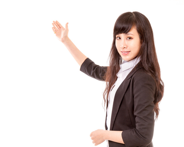 Asian woman showing copyspace or item with her hand - Foto, afbeelding