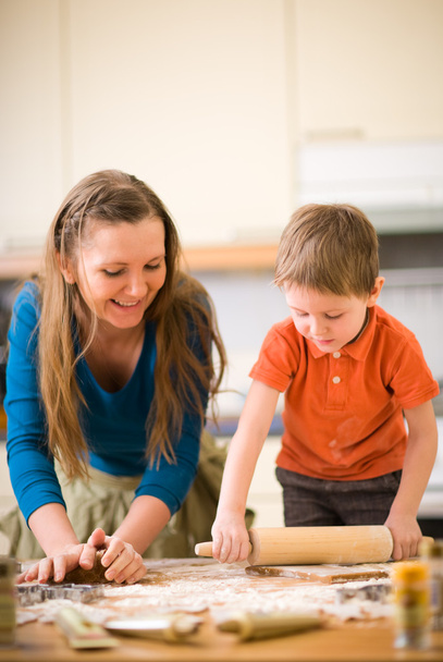 Young mother and son in kitchen making cookies. Focus on hands. - Foto, Imagem
