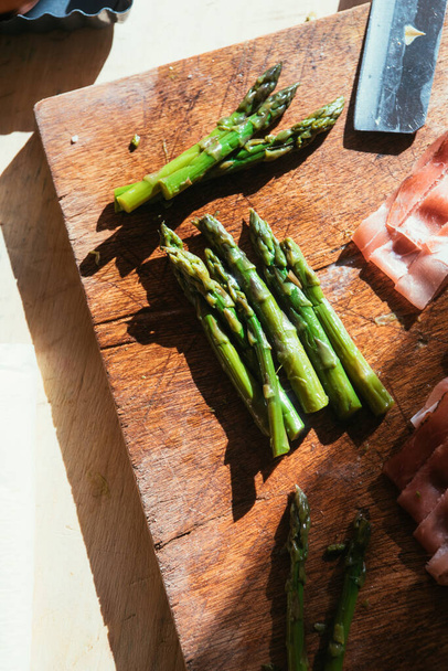 Step by step  recipe preparation of an asparagus and speck tart made with egg yolk, cream , parmisan , brisee pasta, speck and asparagus. prepared cooked and served, top view, flatlay composition - Photo, Image
