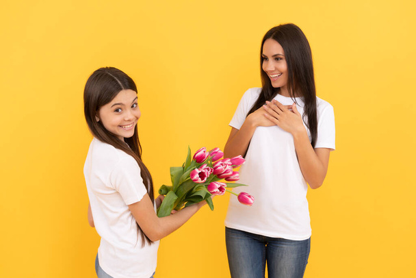 spring flower bouquet gift. childhood and motherhood. love and friendship. happy family day. teen girl with mom. 8 march holiday. mother and daughter with tulip flowers. happy mothers and womens day. - Zdjęcie, obraz