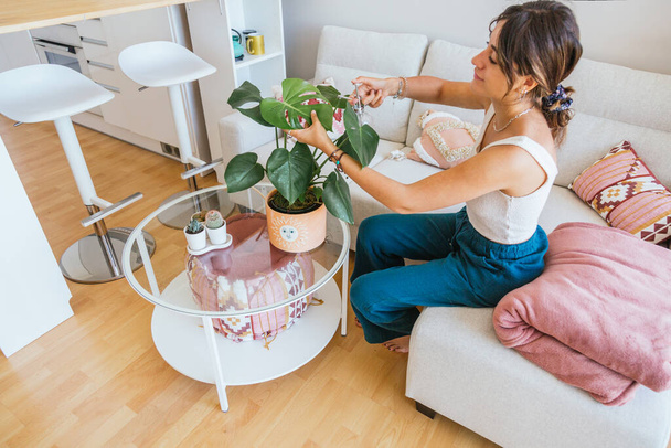 young woman taking care of her plants at home - Photo, Image