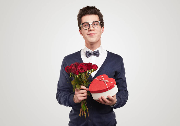Romantic man with bouquet of flowers and gift - 写真・画像