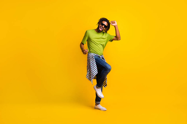 Full length photo of young hipster man happy positive smile enjoy music dance wear casual outfit isolated over yellow color background - Фото, зображення