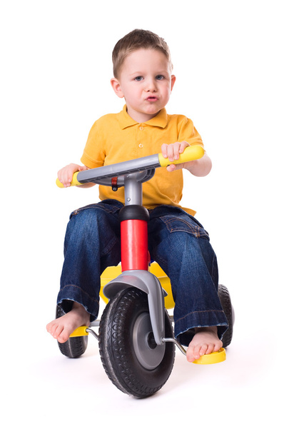 Cute little boy riding a 3-wheel bike. Isolated on white background - Foto, afbeelding