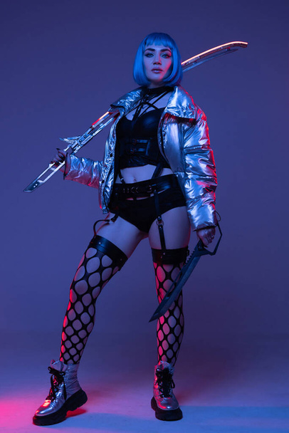 Cyberpunk woman with sword in silver jacket - Photo, Image