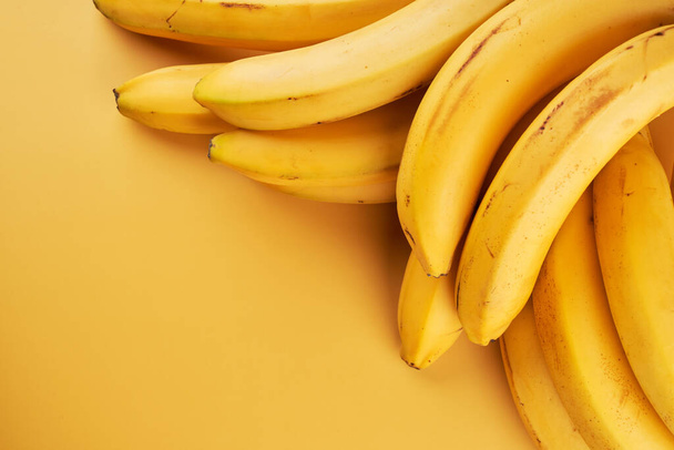 Bananas yellow background with copy space - 写真・画像