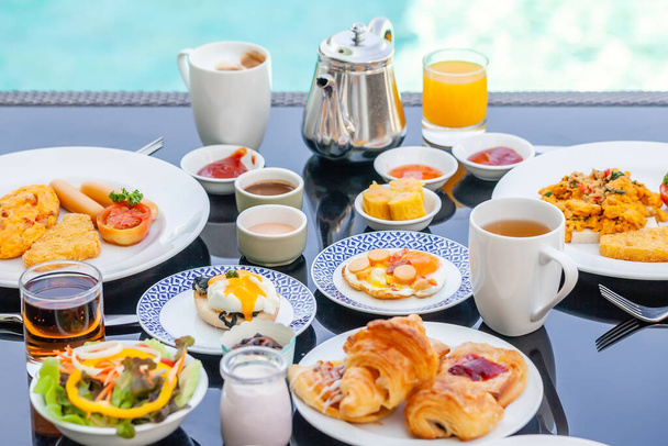 American Breakfast Set on Table Next to Poolside in Resort - Фото, зображення