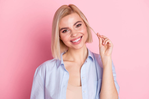 Photo of stunning lovely cute young woman hold hair smile face isolated on pastel pink color background - Foto, Imagem