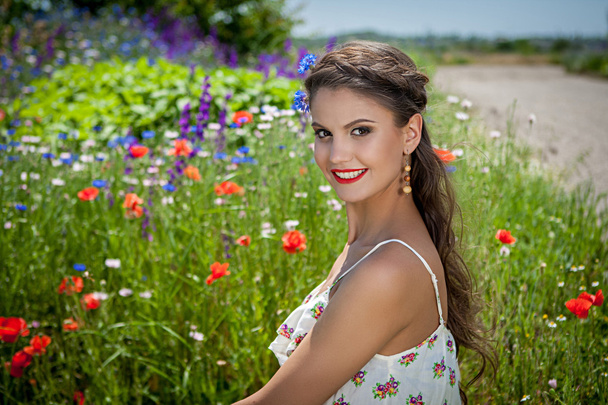 beautiful  happy female  in the wildflowers - Zdjęcie, obraz