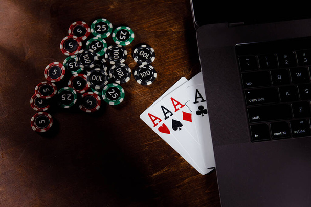 Online gambling and casino concept. Red playing dice, chips and cards on a wooden background - Photo, Image