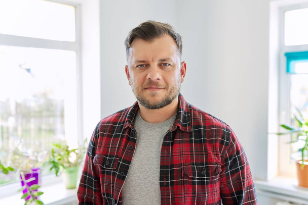Portrait of 40 years old man, smiling male in plaid casual shirt looking at camera - Foto, imagen