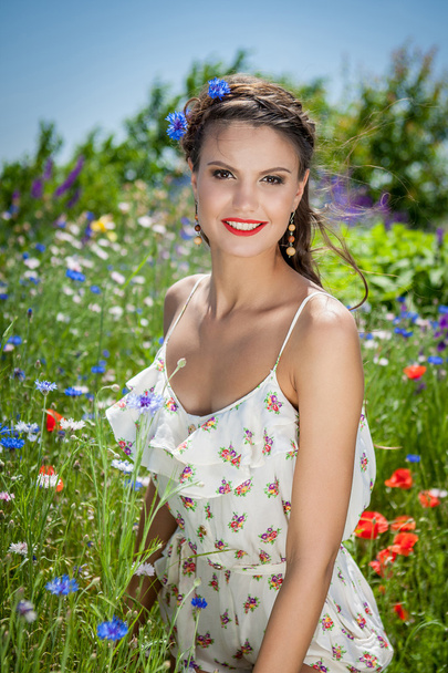 beautiful  happy female  in the wildflowers - Фото, изображение