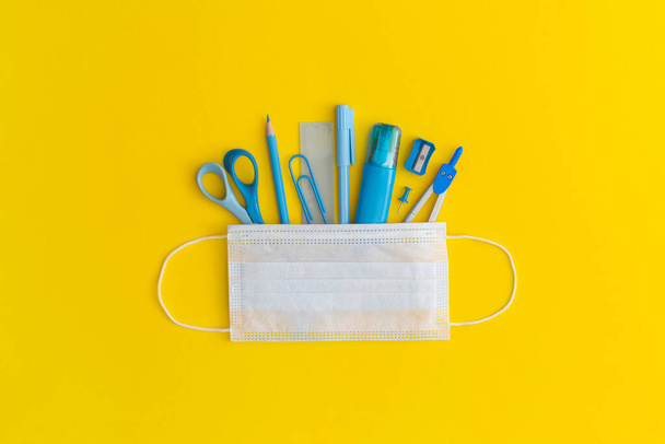 School stationery on a yellow background. Top view with copy space. Flat lay. Back to school concept. - Fotó, kép