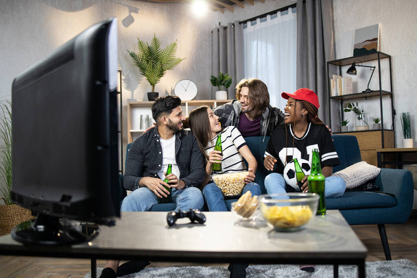 Young multi ethnic people watching football match on TV - Φωτογραφία, εικόνα