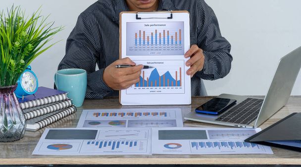Liikemiehet, jotka harjoittavat liiketoimintaa rahoituksen ja laskenta laskimet ja analysoida kaavioita kustannuksista investoimalla kiinteistöjen ja muiden verojärjestelmien - Valokuva, kuva