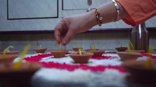 Indian Womans Hands Making Candles In Clay Candle Holders - close up - Filmmaterial, Video
