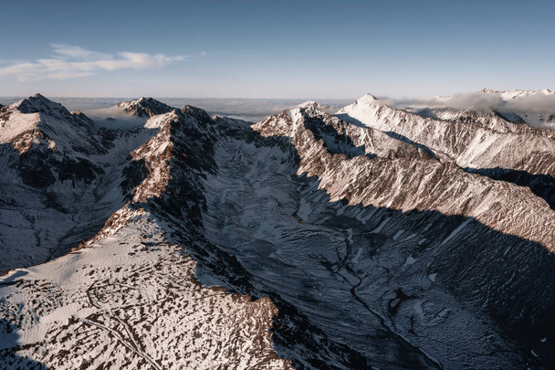 Aerial view of Mountain peaks in snow at sunse - Foto, imagen