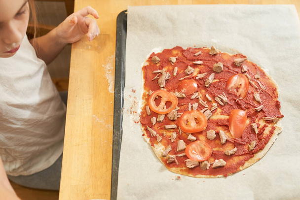 The girl cooking healthy gluten-free pizza with beef. Cooking together. - Photo, image
