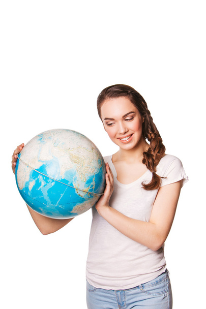 beautiful smiling young lady holding a world globe. isolated on white - Foto, afbeelding