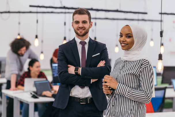 Portrait of a formal businessman and young African American businesswoman posing with their team in a modern startup office. Marketing concept. Multi-ethnic society. - Foto, Imagem