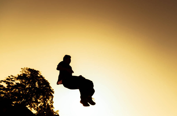 Флип-бросок в воздухе в исполнении спортсмена в скейт-парке - Фото, изображение