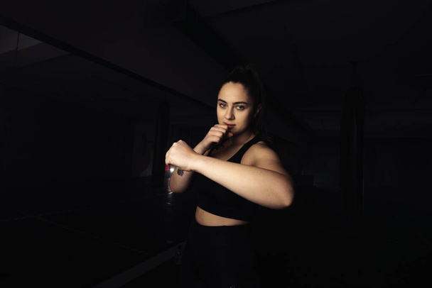 Portrait of a beautiful boxer girl with white hands - Φωτογραφία, εικόνα