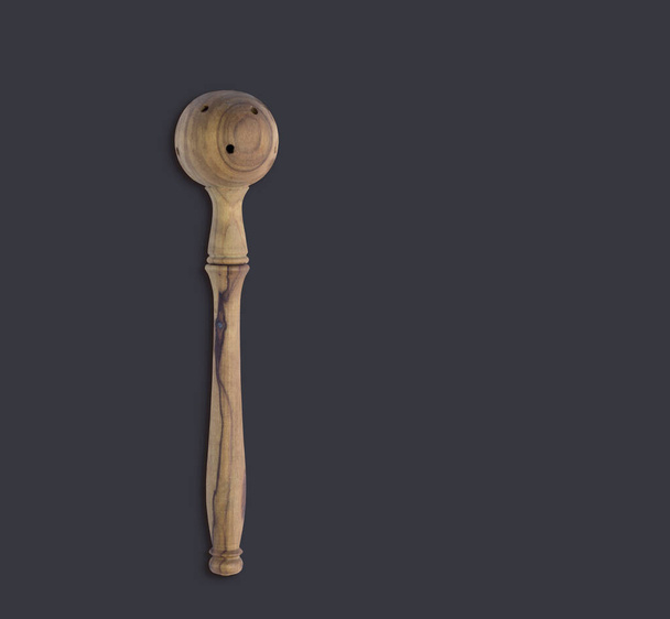 Top up view olive wooden olive spoon isolated on dark background. suitable for your design element. - Zdjęcie, obraz