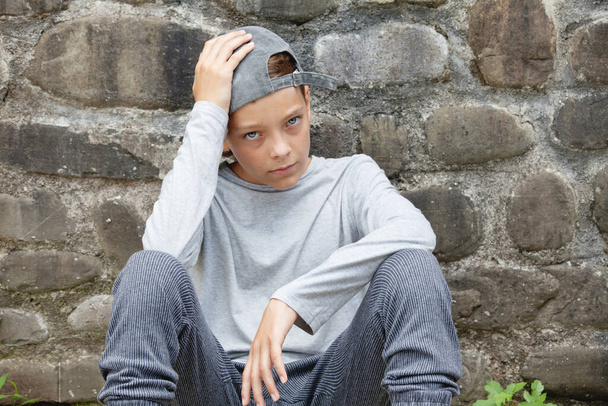Sad teen outdoors. Unhappy teenager  - Фото, изображение