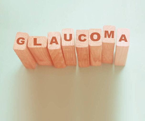 Glaucoma word made with wooden blocks, eye healthcare medical concept. - Zdjęcie, obraz