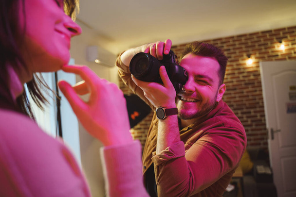 Photographer taking pictures of his female model with professional camera - Valokuva, kuva