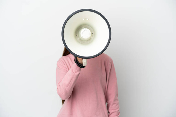 Little girl over isolated white background shouting through a megaphone to announce something - Photo, Image