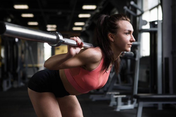 Female athlete doing goodmorning exercise at functional training gym - Photo, Image
