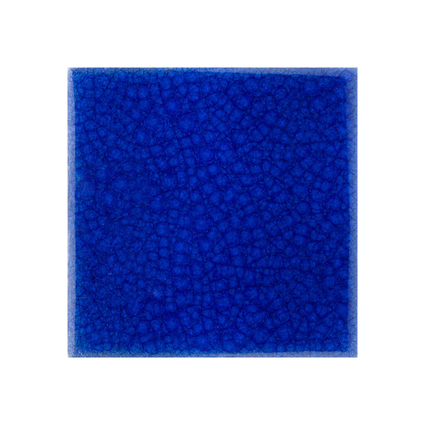 A closeup shot of a blue ceramic tile with grungy patterns isolated on a white background - Foto, Imagem