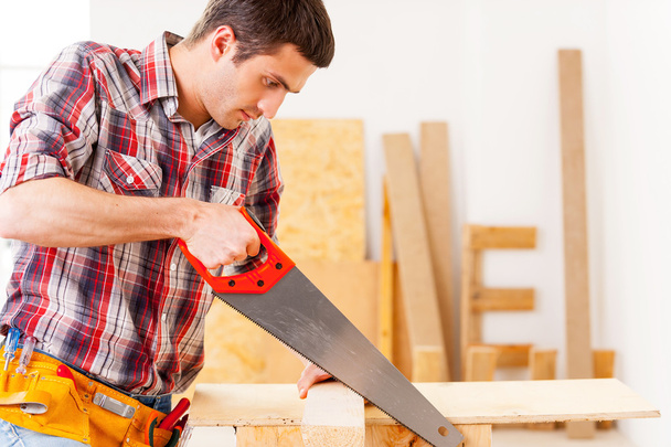 Handyman using saw. - Фото, зображення