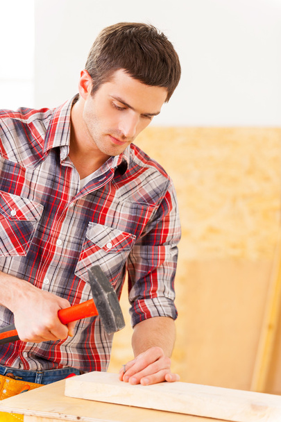 Handyman hammering nail - Photo, image