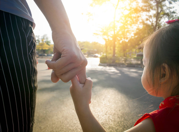 Family concept: baby hold hands with his lovely mom in sunlight - Foto, Imagem
