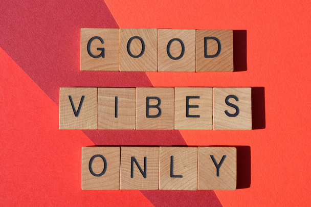 Good Vibes Only, positive phrase in wooden alphabet letters isolated on red background - Foto, Imagen