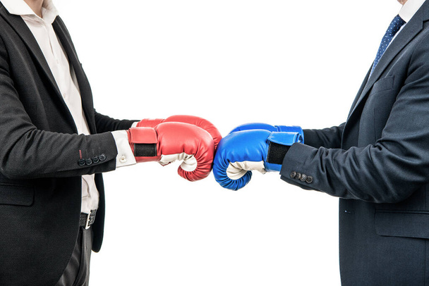 Biznesmeni lub politycy przycięty widok w garniturach biznesowych nosić rękawice bokserskie gotowe do walki na biało, opozycja. - Zdjęcie, obraz