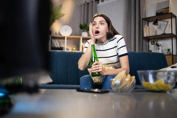 Emotional woman watching football world cup on TV - Foto, Imagen